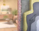 Corte de pared que muestra el aislamiento y los materiales de construcción, ilustrando cómo funciona una casa passivhaus que es eficiente energéticamente.