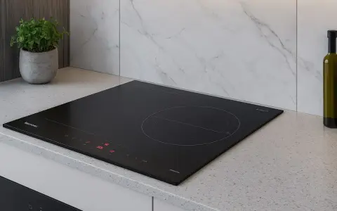 Placa de inducción negra moderna en encimera de granito. Considera los requisitos para instalar una placa de inducción para una cocina elegante.