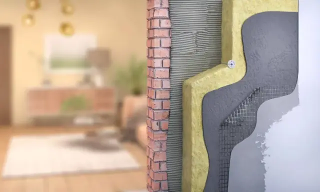 Corte de pared que muestra el aislamiento y los materiales de construcción, ilustrando cómo funciona una casa passivhaus que es eficiente energéticamente.