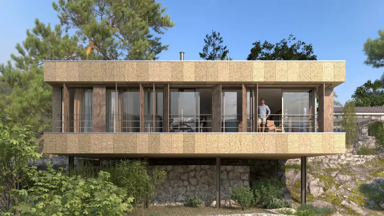 Modern house with a textured facade, large windows, and a balcony. A man stands on the balcony, enjoying the view. This design is perfect to cambiar fachada casa.